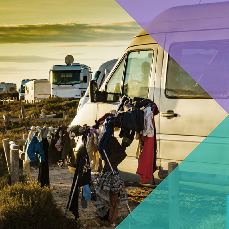 photo of a pair of hands hand-washing clothes in soapy water
